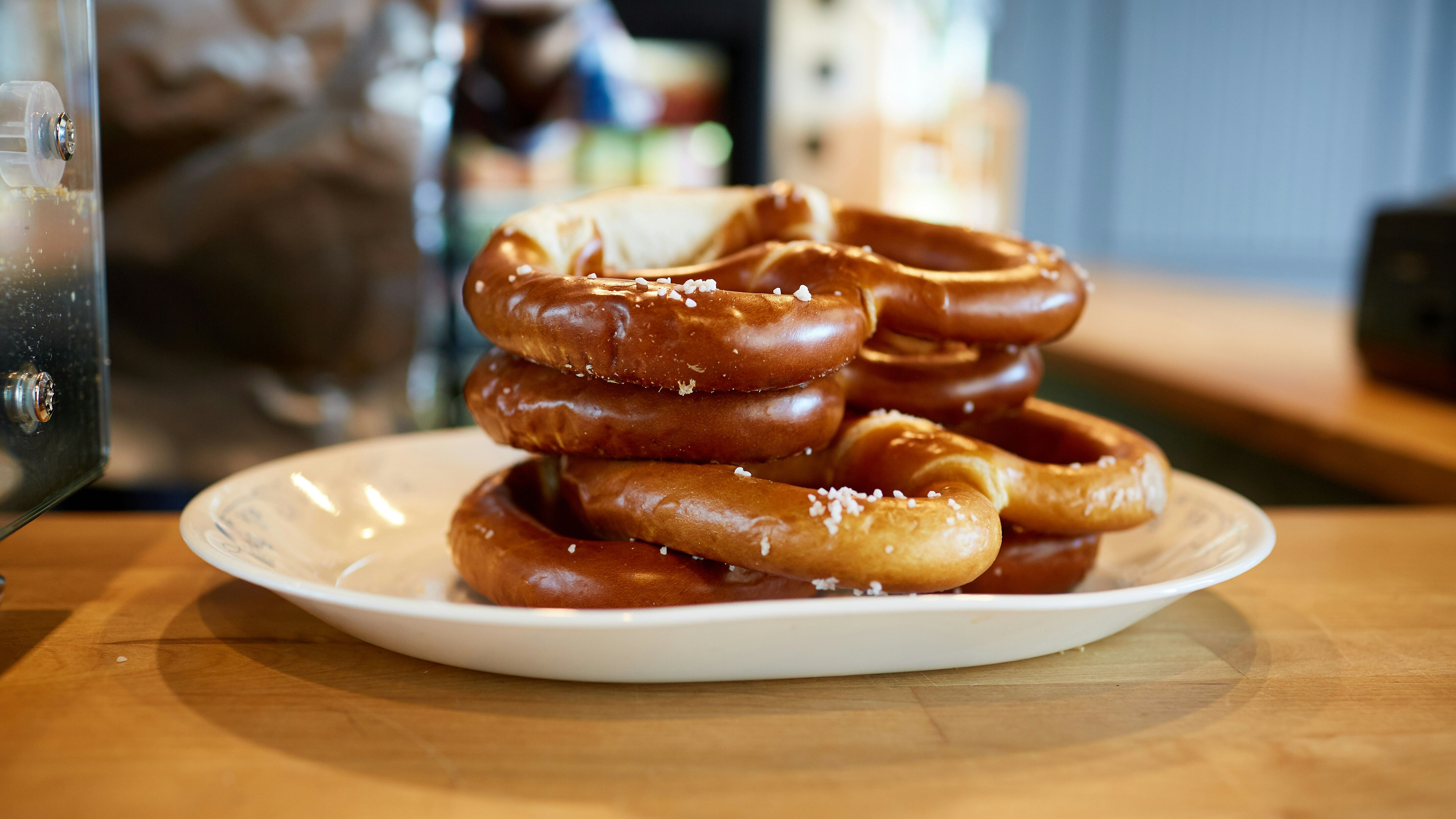 A fresh stack of German prezels sits on a white plate