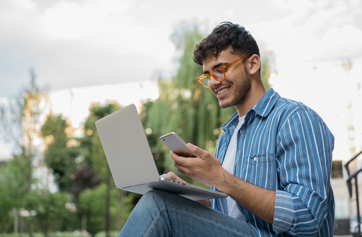 Man with a phone and computer