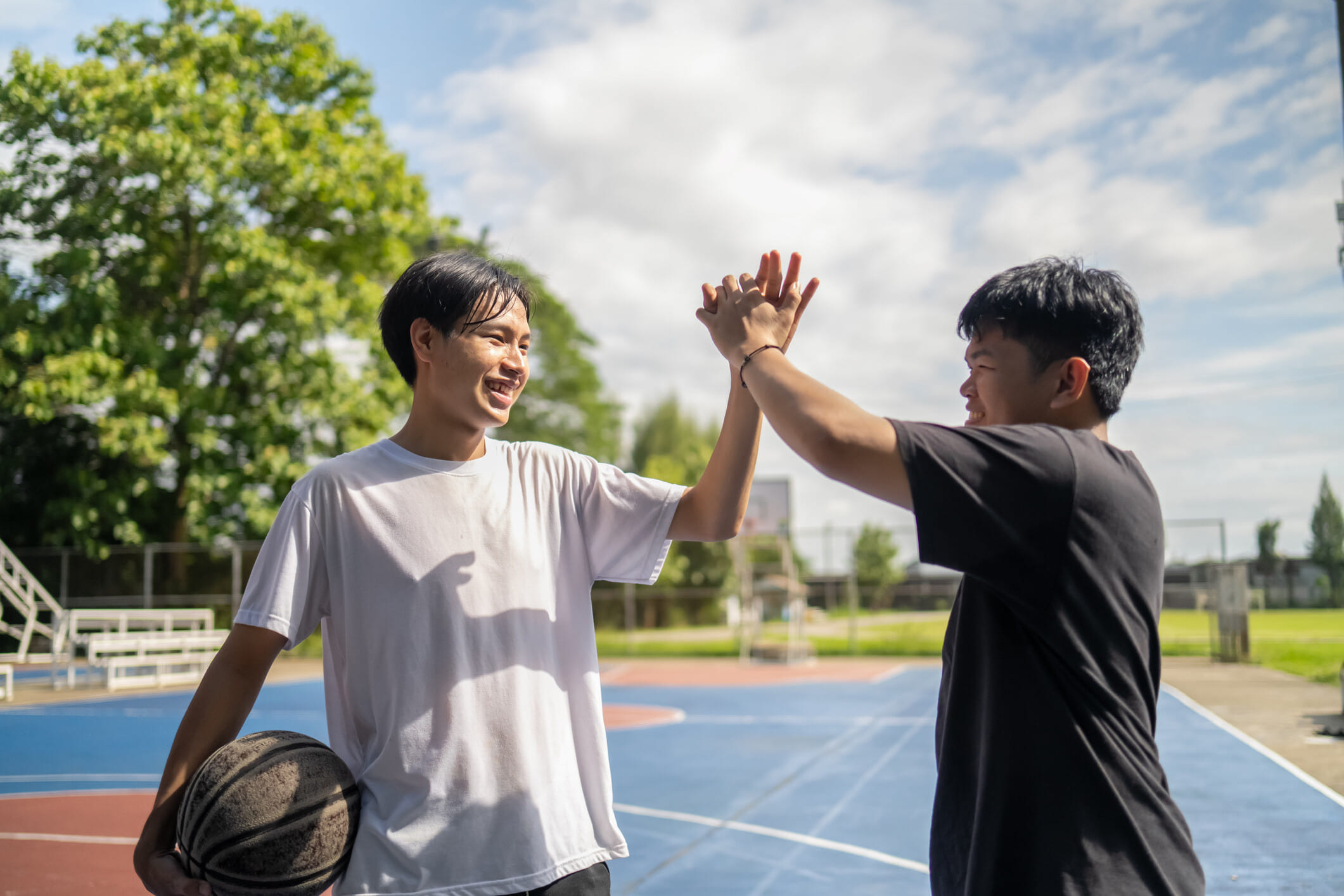 Two teenagers on a basketball court