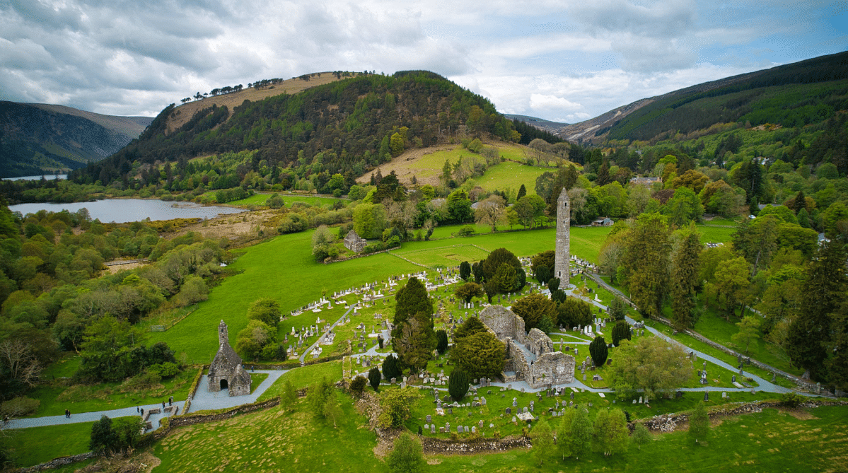 Medieval monastery among rolling hills in Glendalough, Ireland