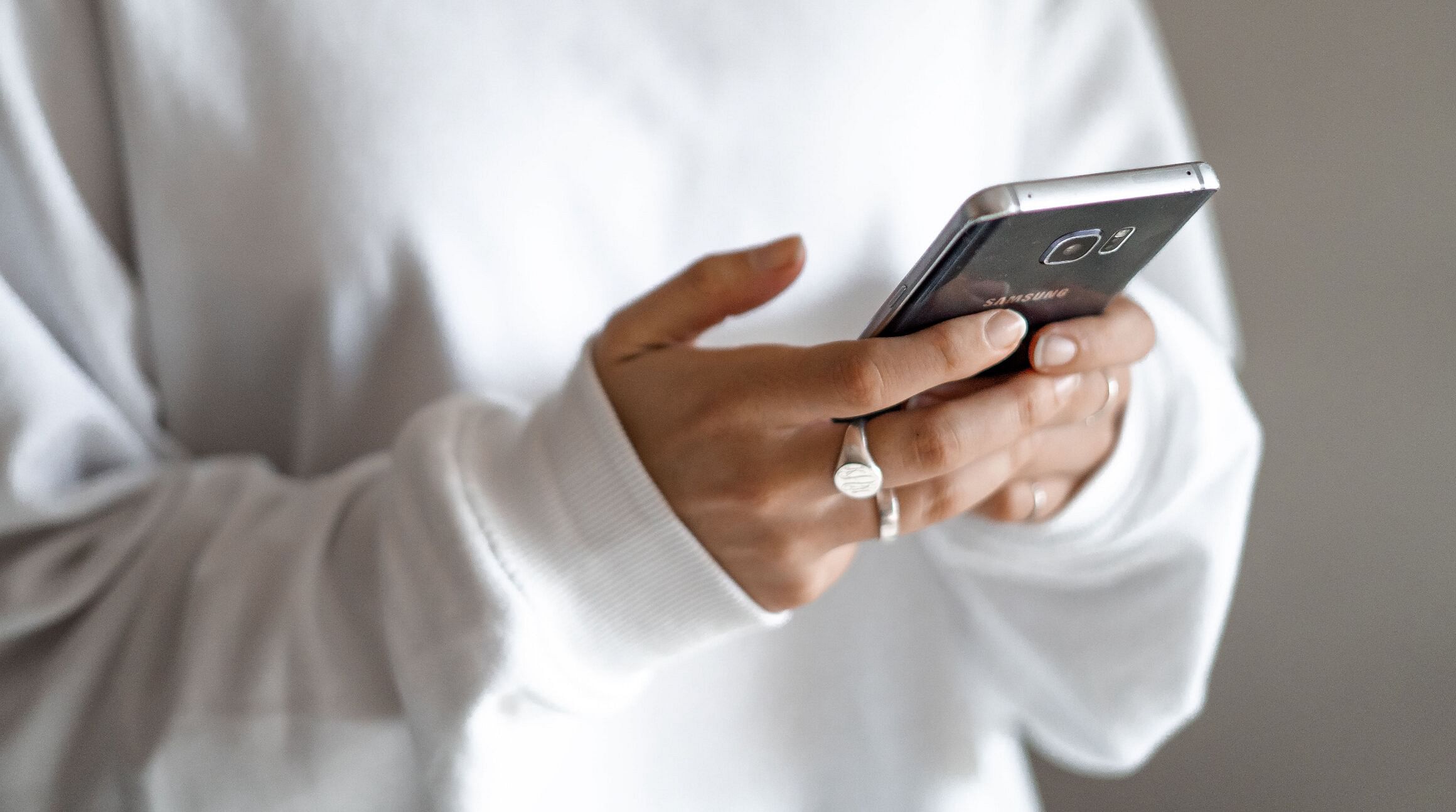 woman texting on smartphone