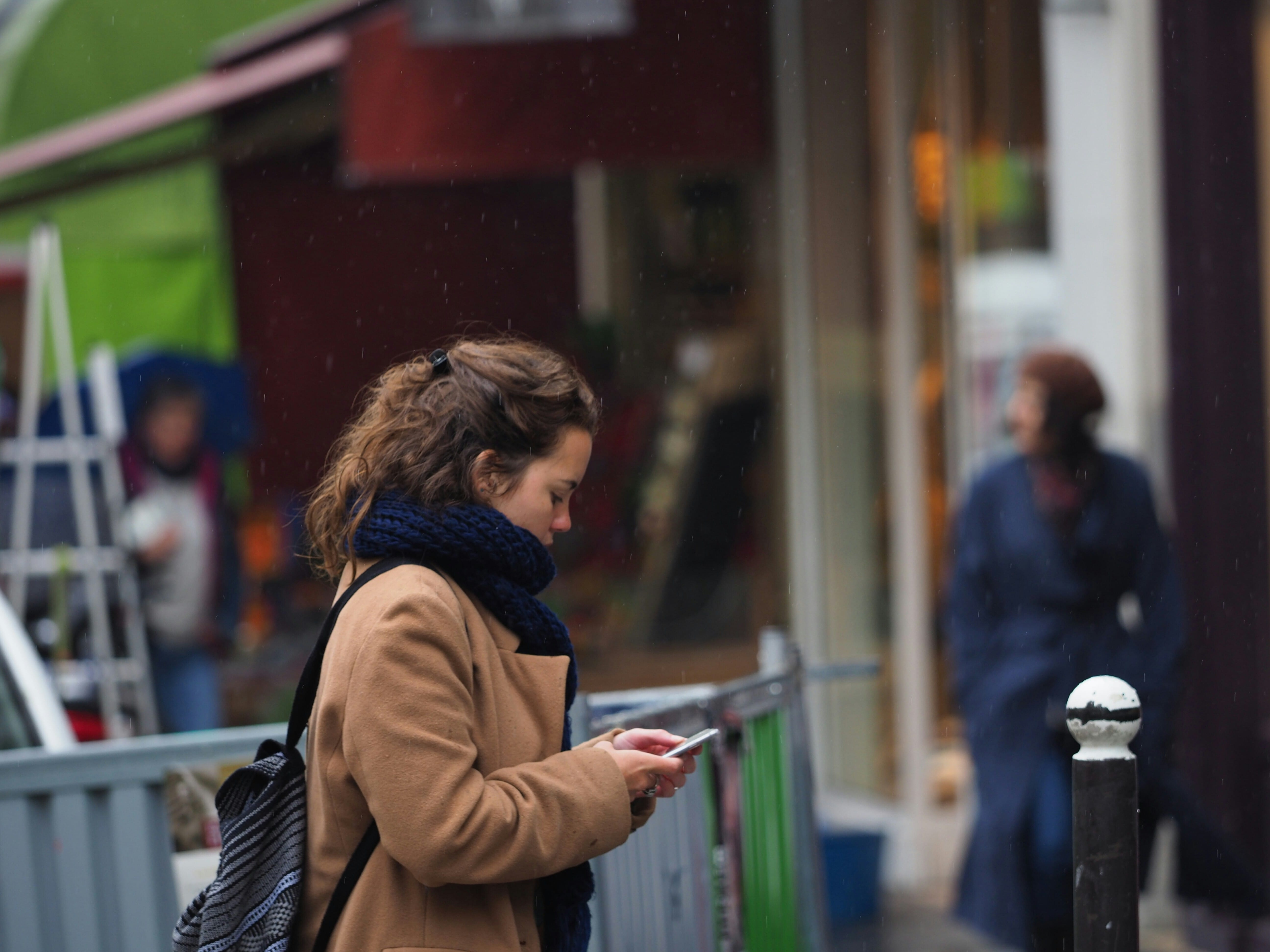 A woman using her phone in the street