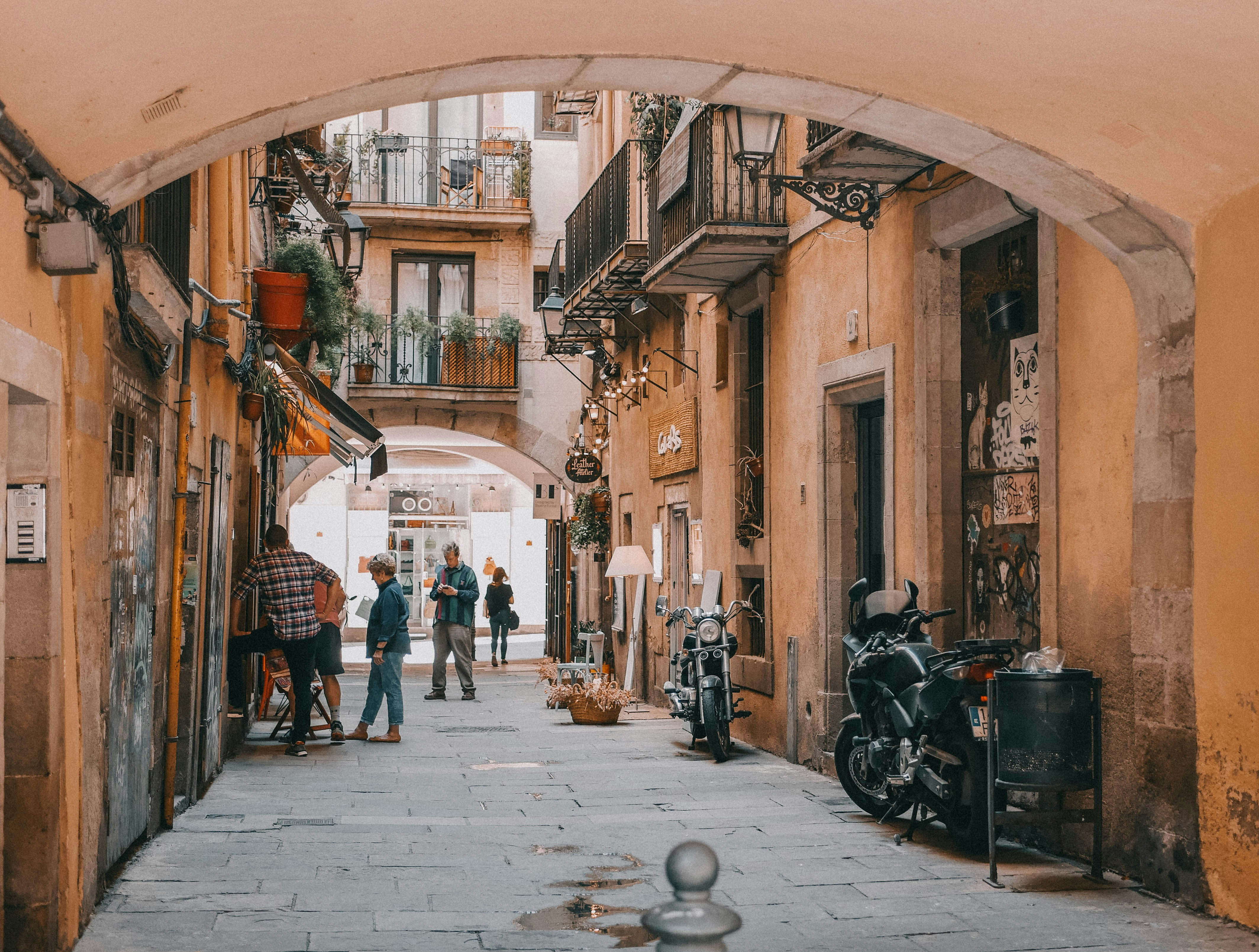 A cozy Barcelona alley with shops and tourists.