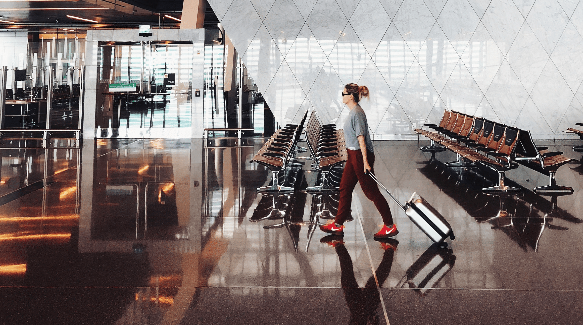 woman walking through airport terminal