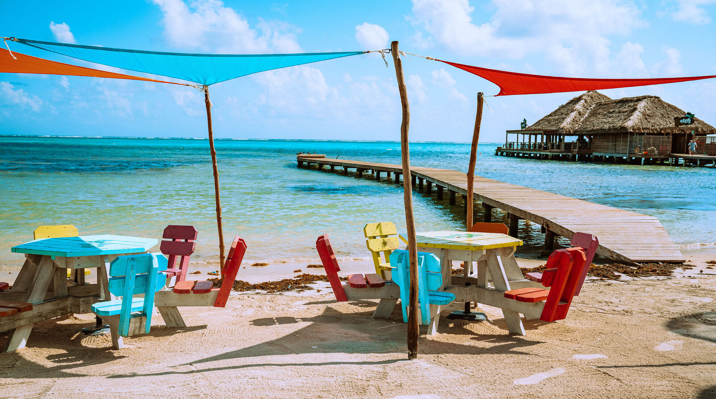 Colorful chairs and umbrellas on a beach in Ambergris Caye, Belize