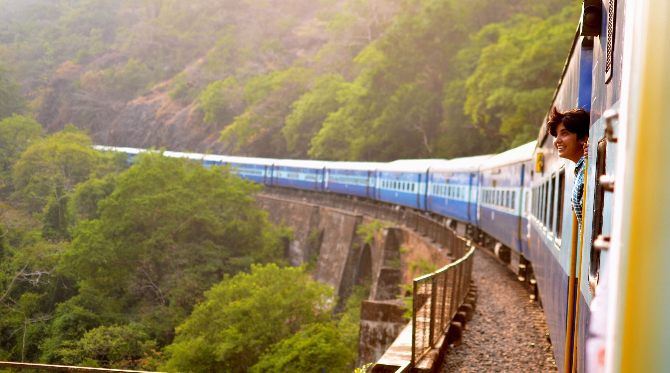 Person looking out the window on a train in India