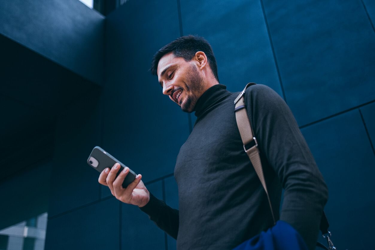 Man with a turtleneck on his phone