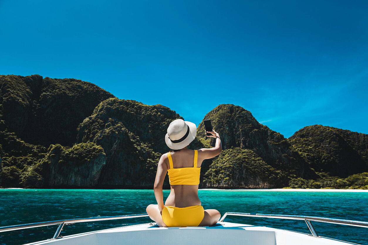 Woman using an eSIM on her phone in Thailand