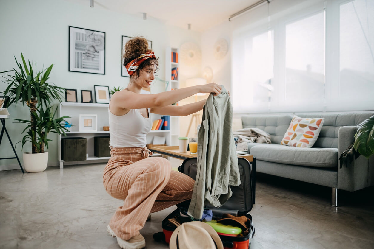 Woman packing a suitcase before her trip