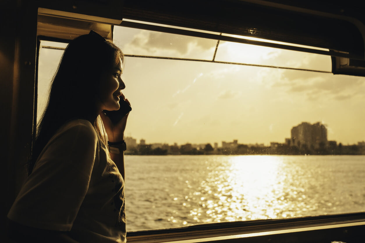 Frau auf dem Nil mit Handy in der Hand