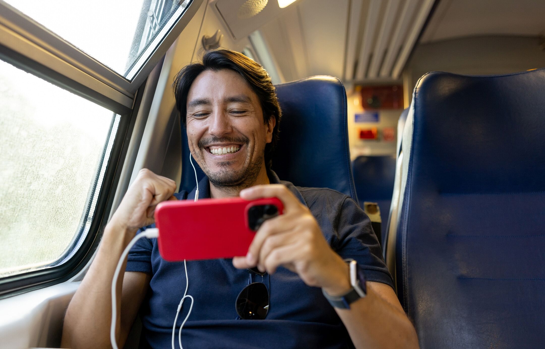 Man traveling and playing mobile games