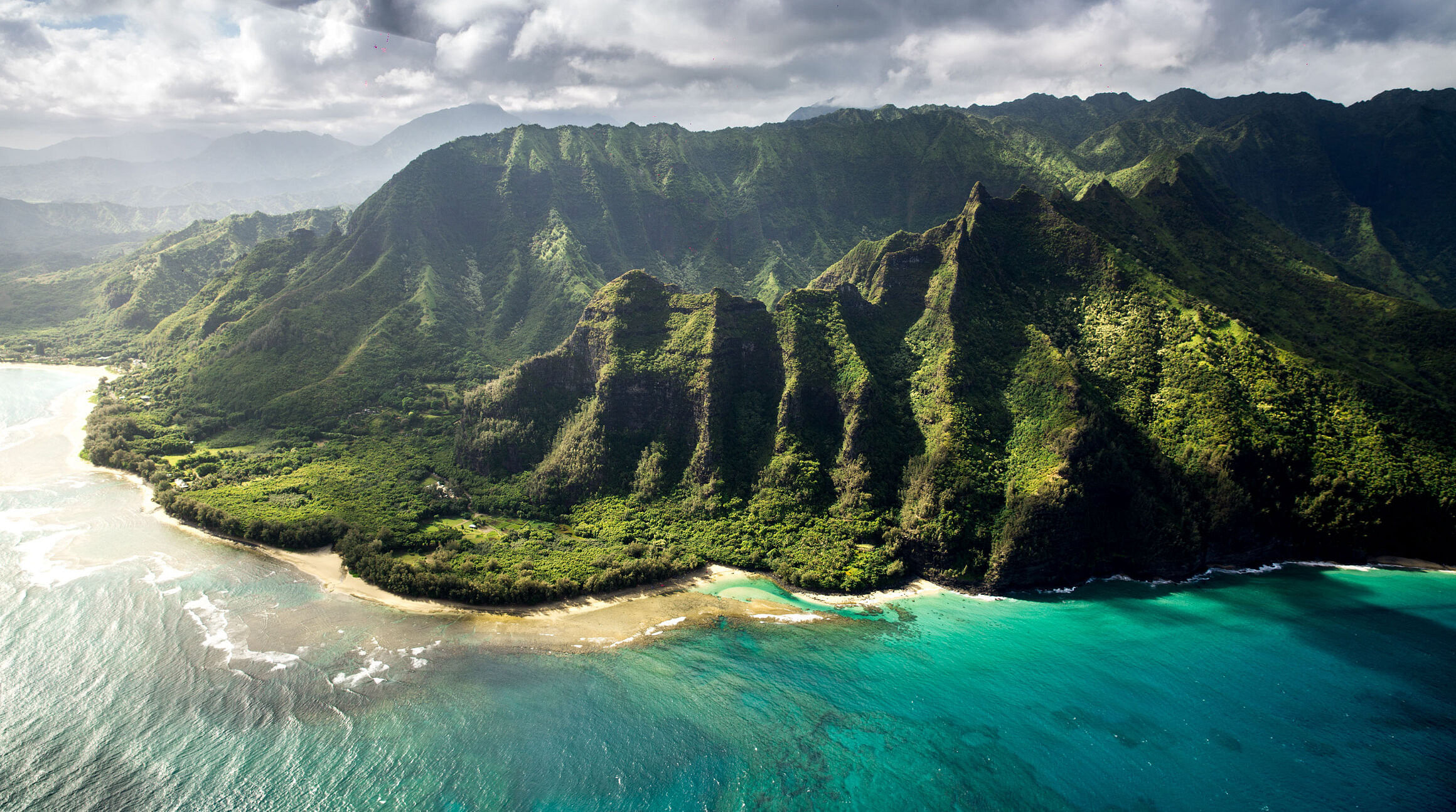 View of turquoise waters and emerald cliffs in Hawaii