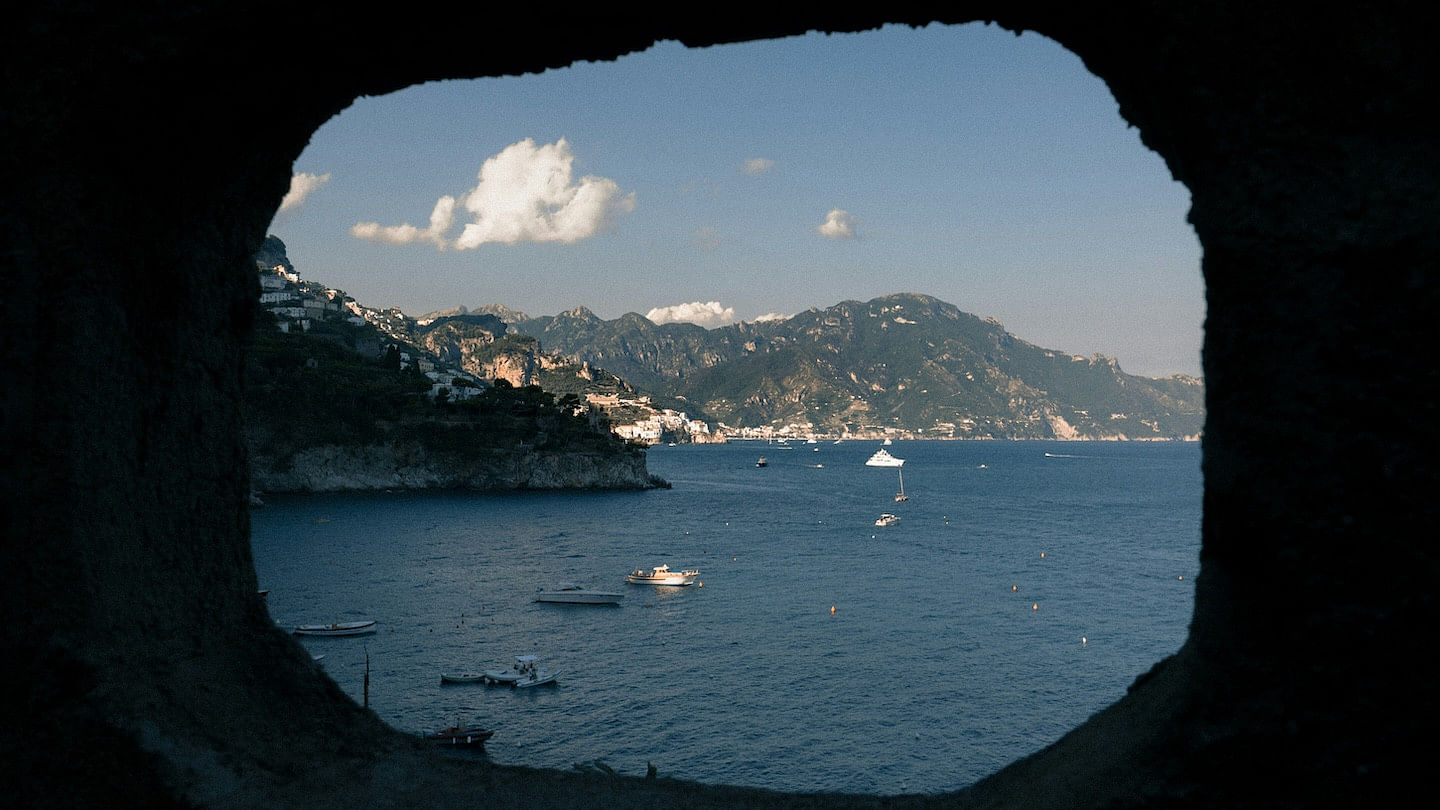 Looking at the Amalfi Coast through a perfectly framed hole in a rock