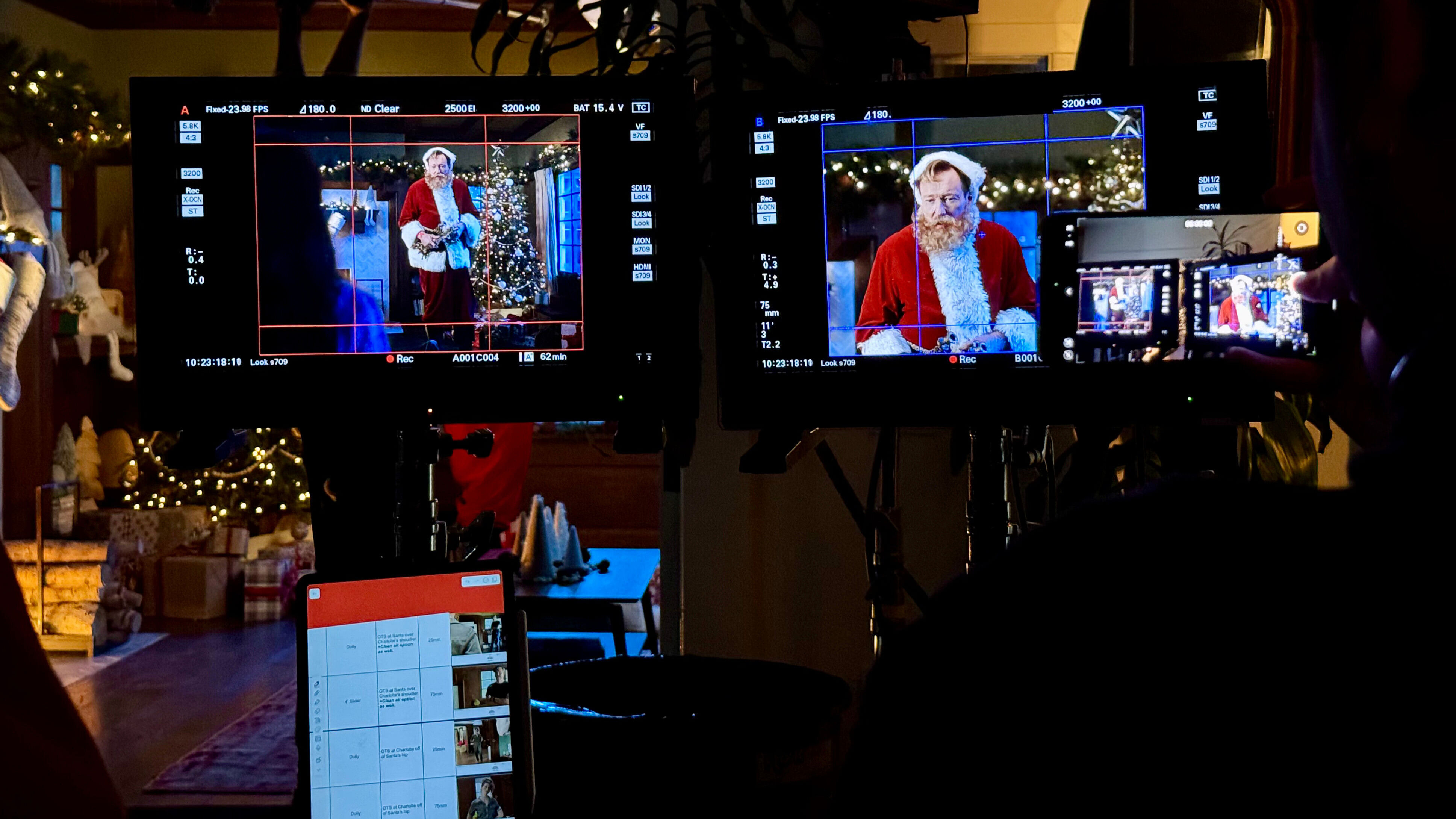 Conan O'Brien, dressed as santa, viewed through live-feed video monitors in a dark room