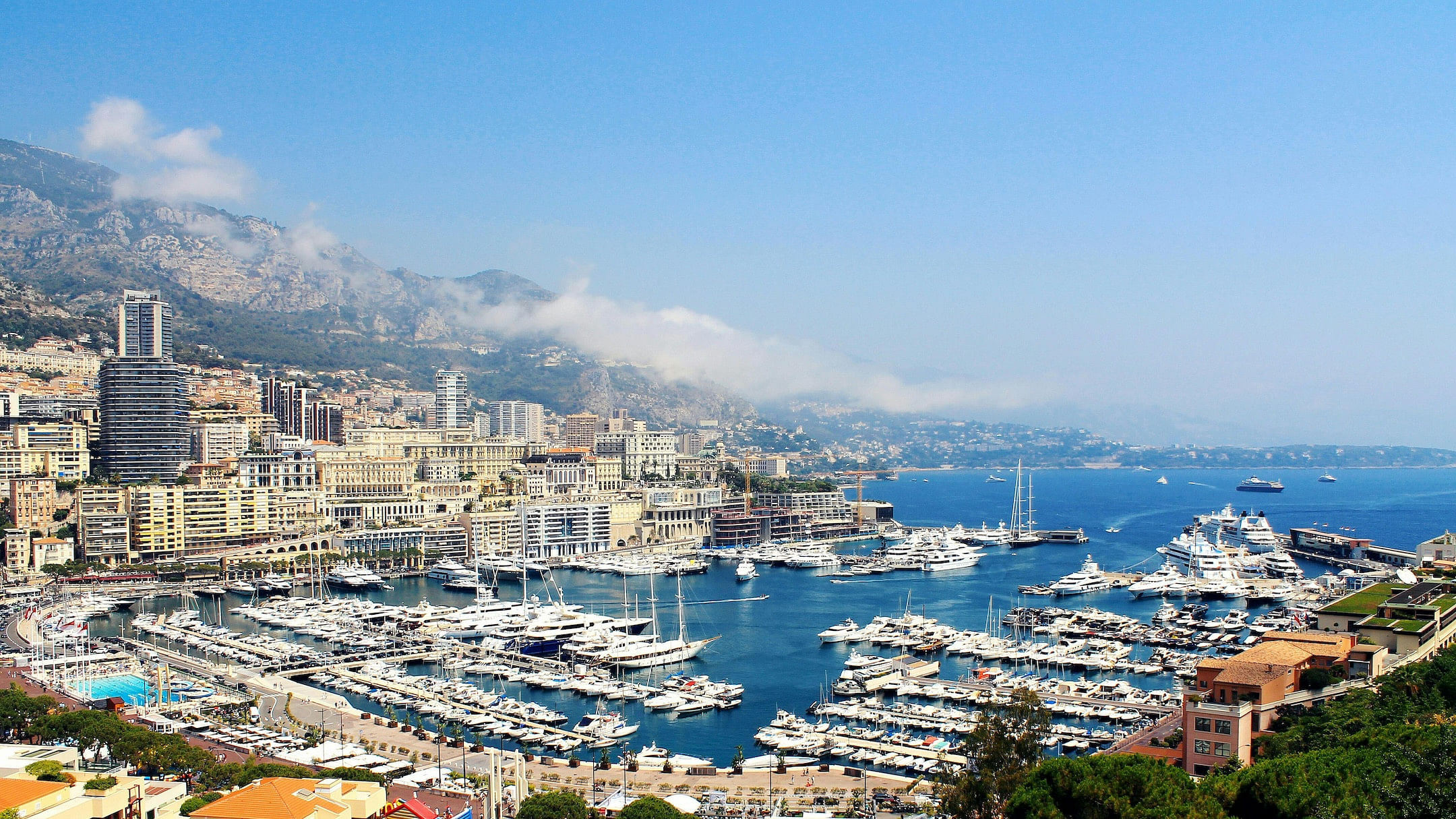 A sunny afternoon along the French Riviera depicting boats and low-hanging clouds