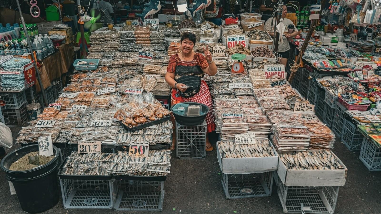 Woman waving at camera in a Manila fish market