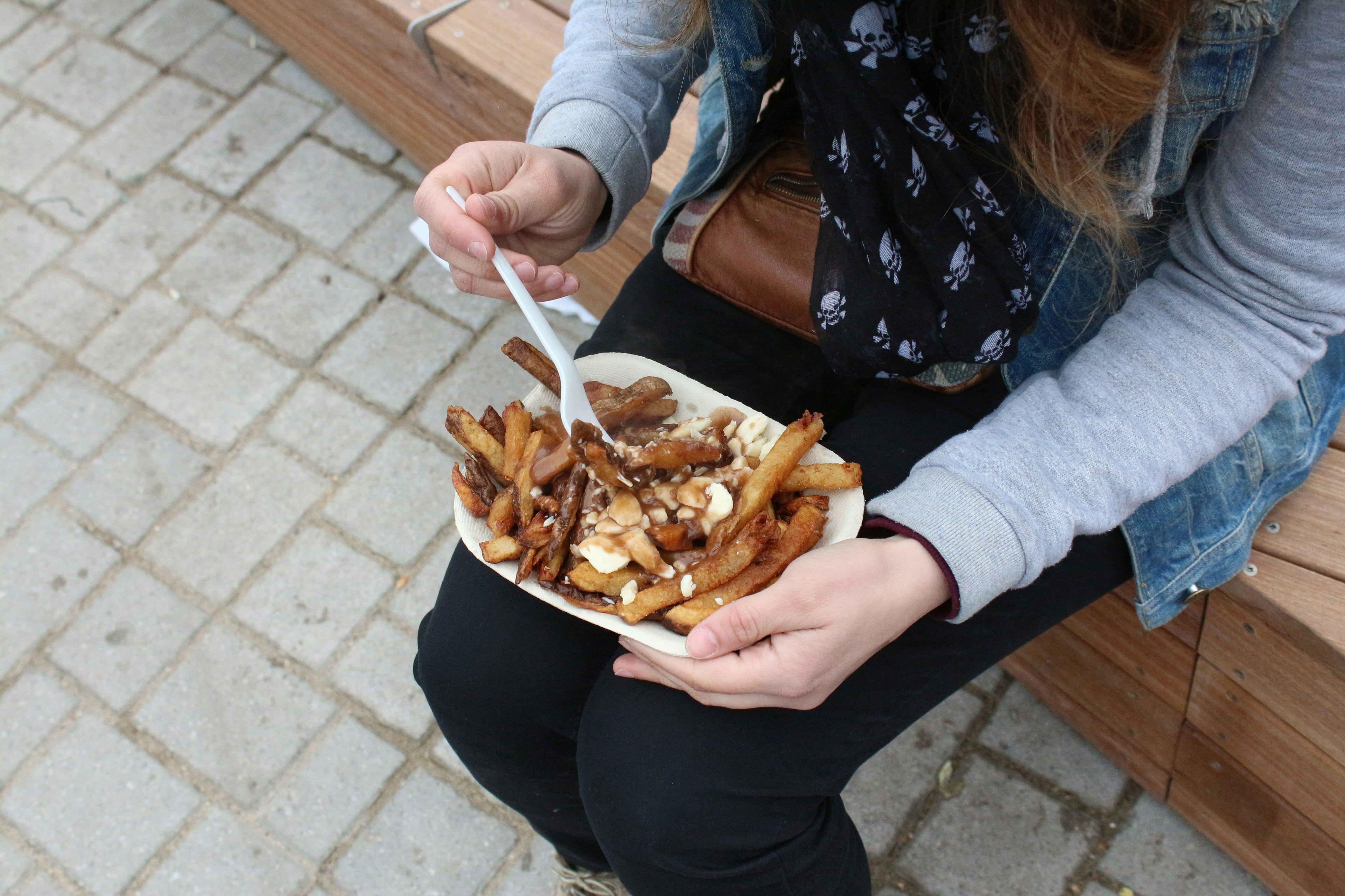 Poutine in a woman's lap