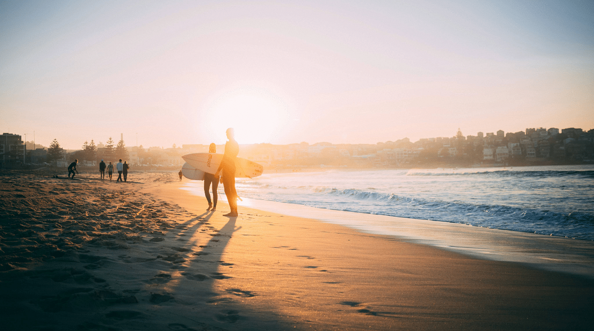 Two surfers on a beach in Australia