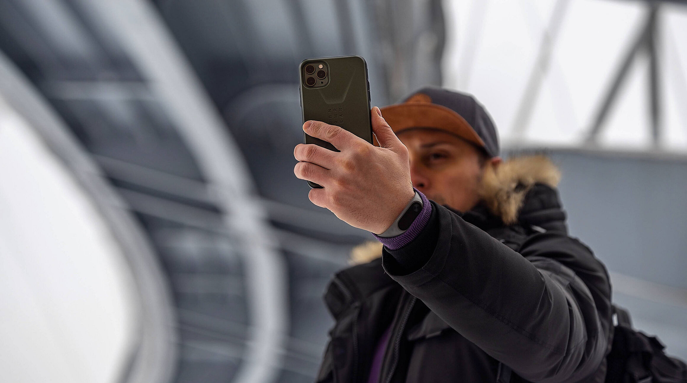 traveler using an iphone under the Eiffel Tower
