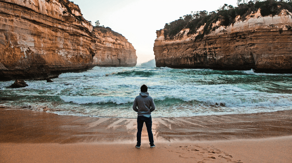 Traveler looking at the ocean along the Great Ocean Road, Australia