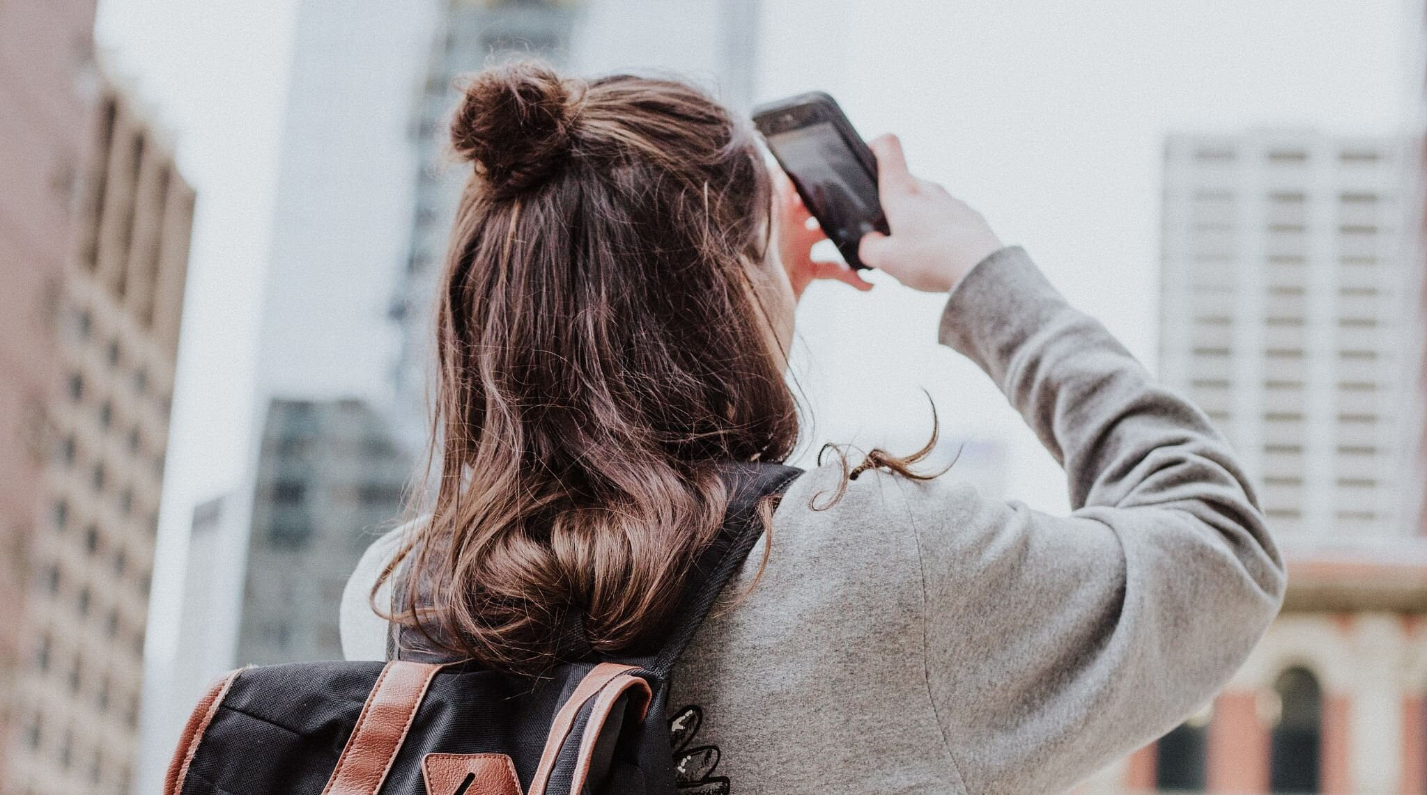 lady holding phone and taking photos