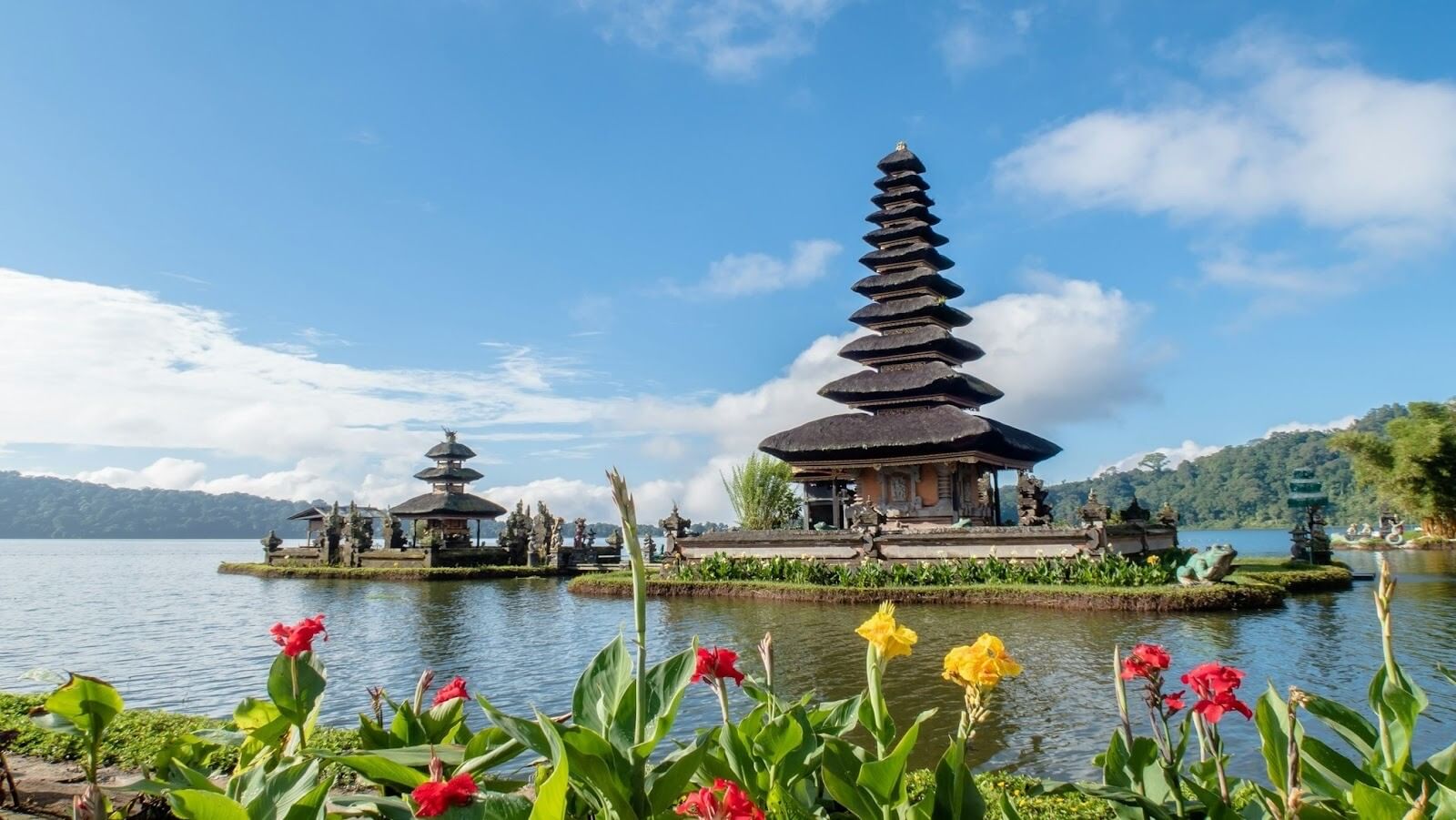 A group of pagodas sitting on top of a body of water