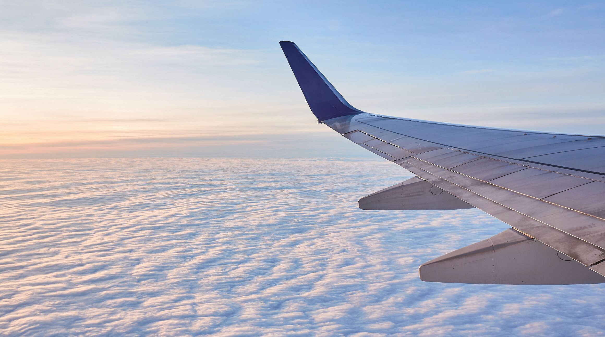 airplane wing and clouds