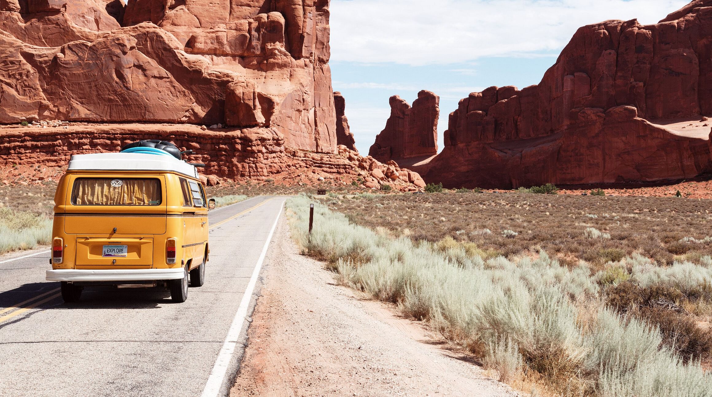 Yellow VW bug driving in Arizona