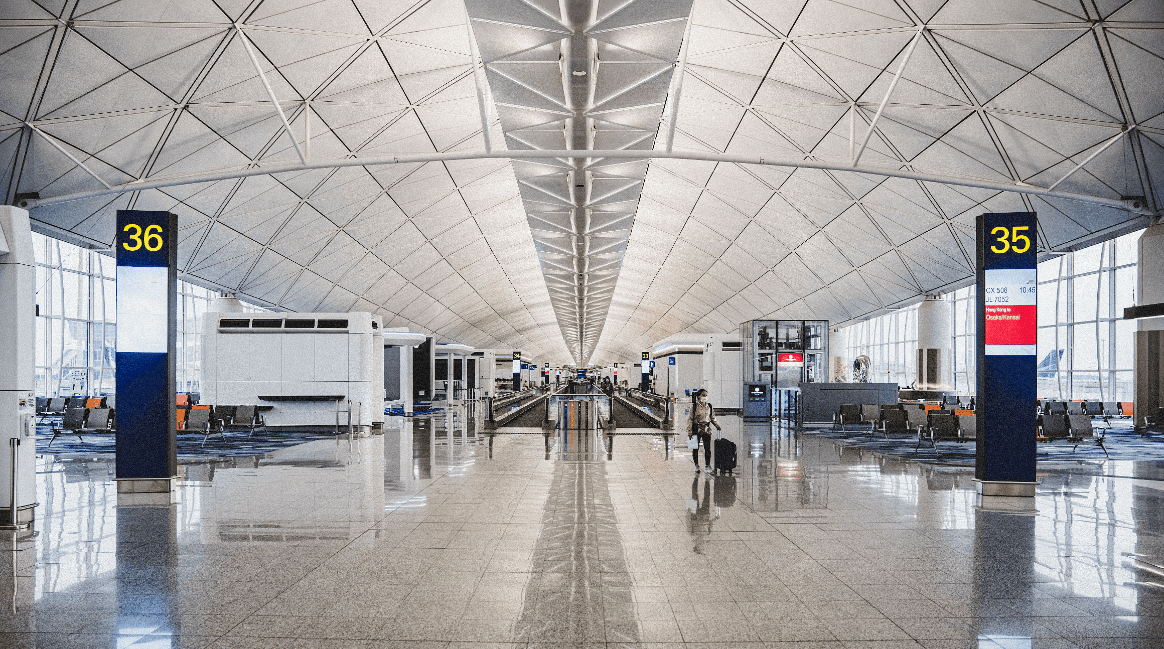 empty airport with one person standing