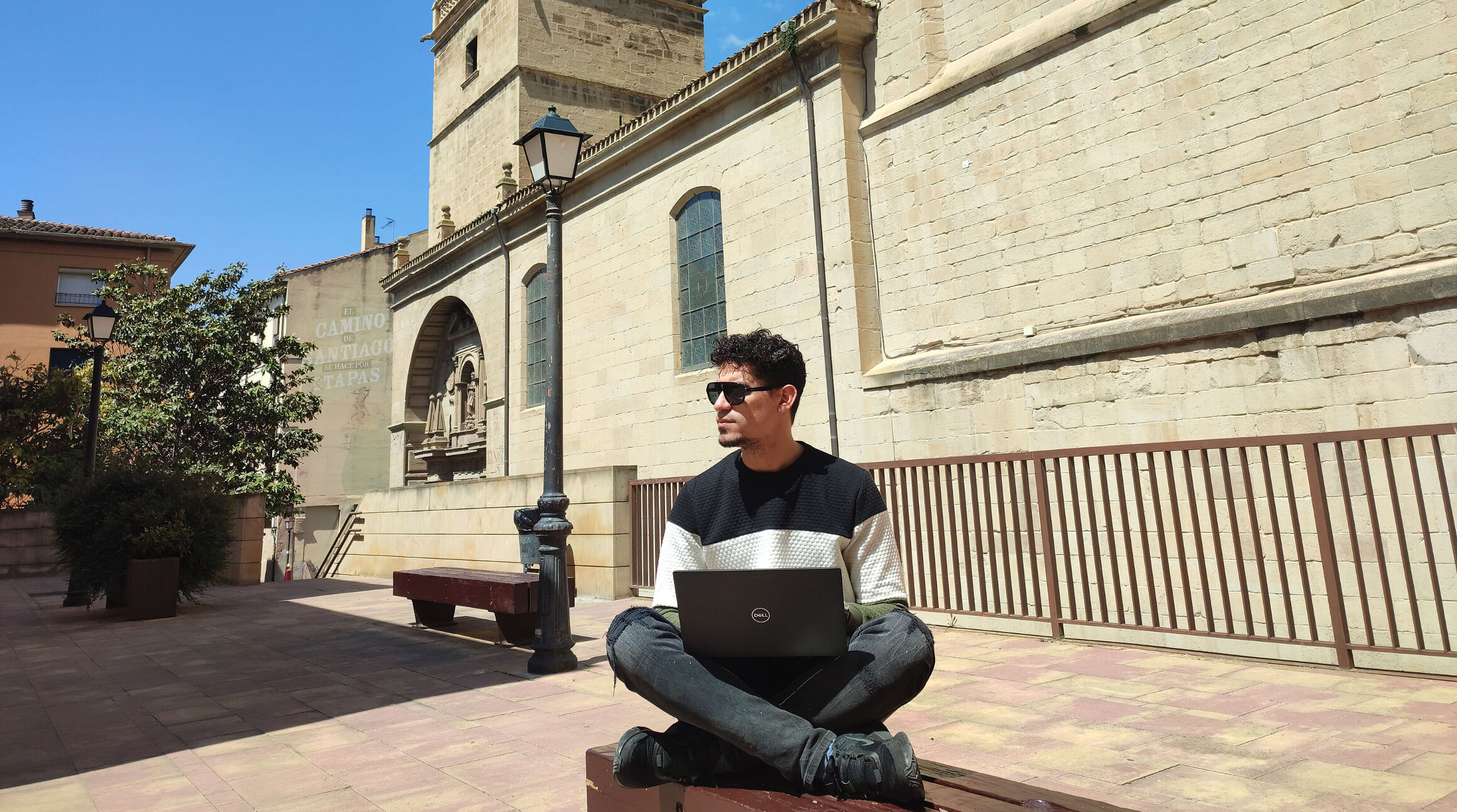 digital nomad working from a plaza in spain