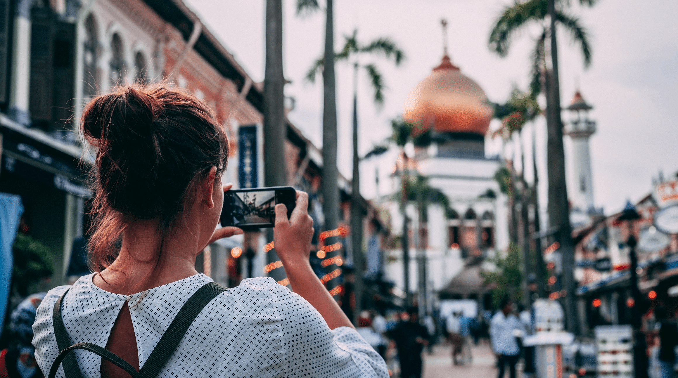 woman taking travel photo with a smartphone