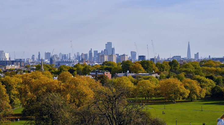 A photograph taken at the brow of Primrose Hill in London, with some of the capital city's skyline in view, to illustrate a blog post entitled 'How to Spend New Year's Eve in London'.