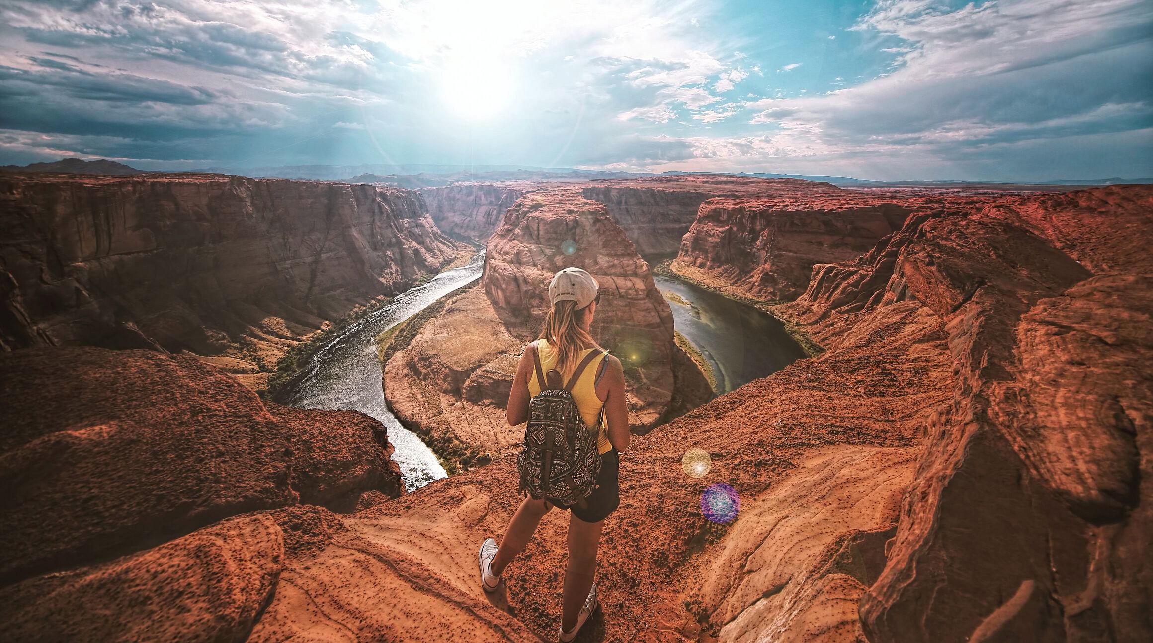 solo traveler looking out over the grand canyon at sunset