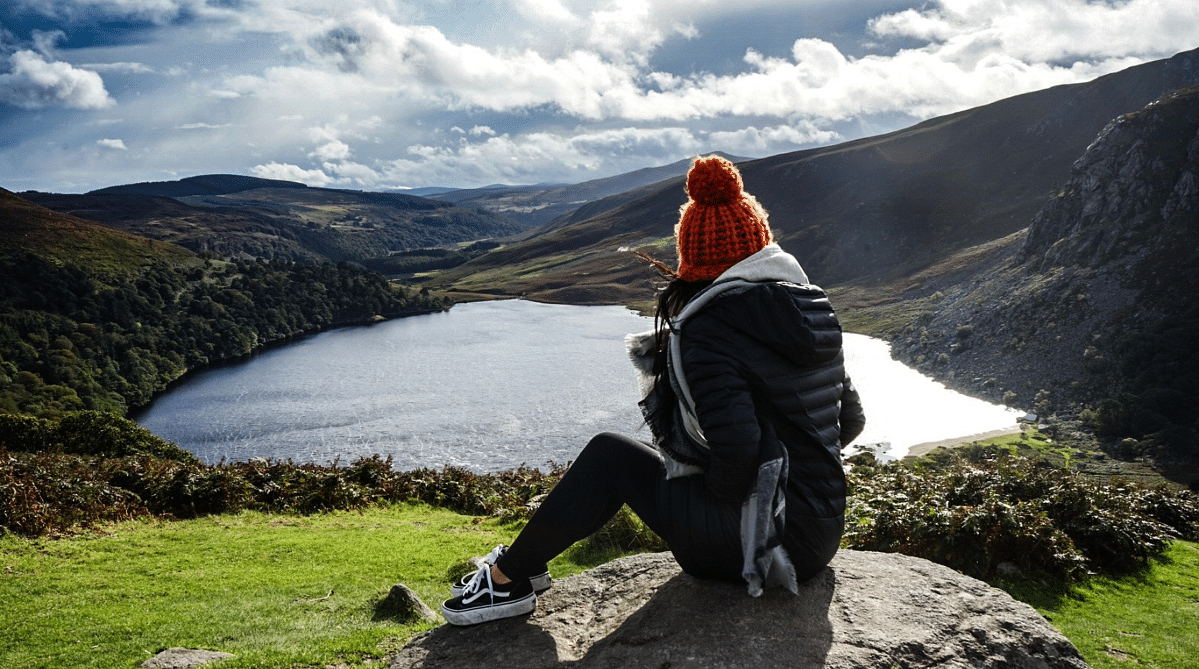 Traveler overlooking a lake in Wicklow, Ireland