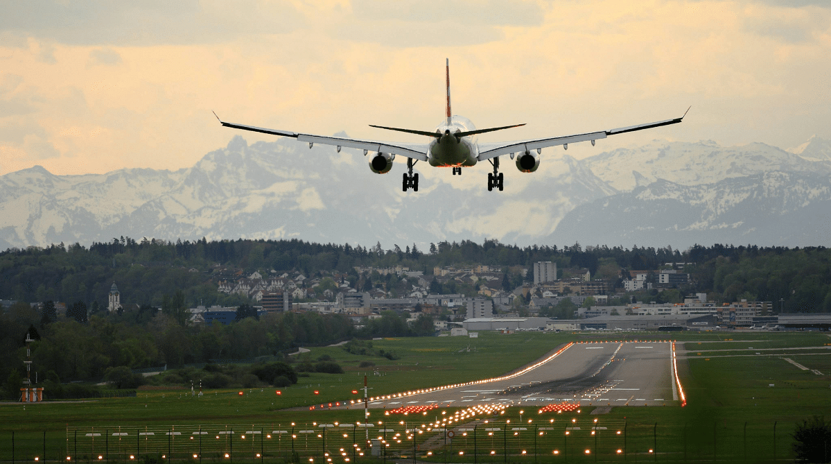 Airplane landing at an airport in the Swiss alps.