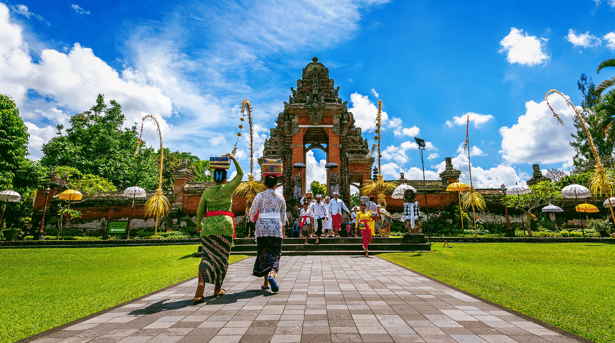 Balinese people in traditional clothing outside Taman Ayun Temple
