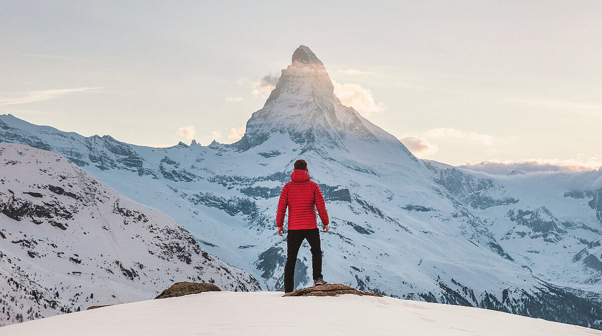 Man standing across from the Matterhorn in Zermatt