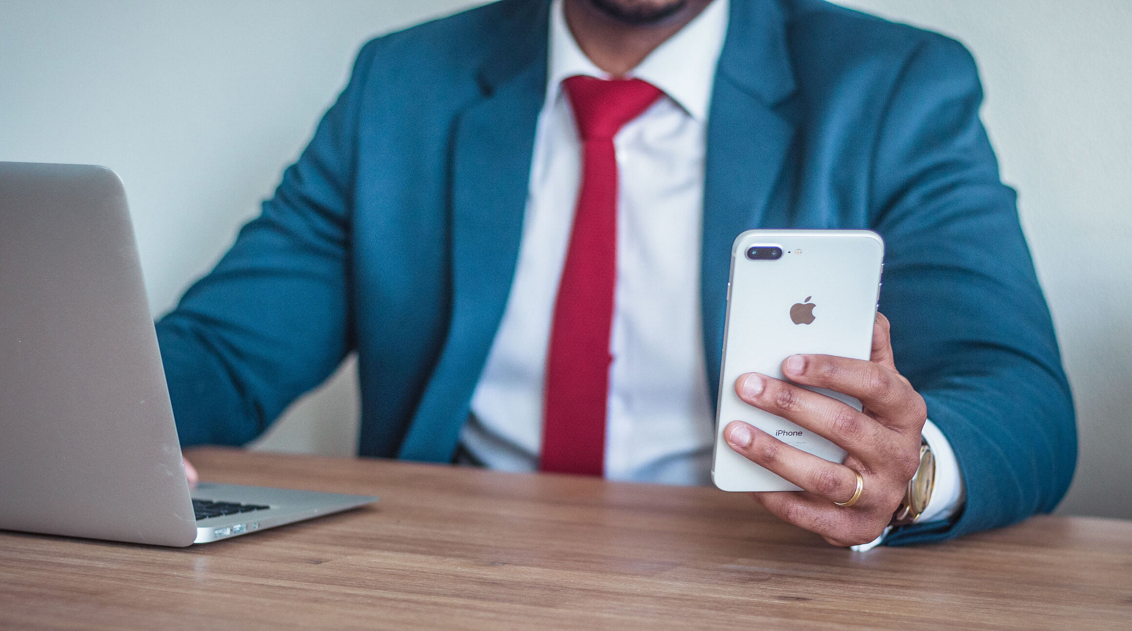 business person working on a laptop and smartphone