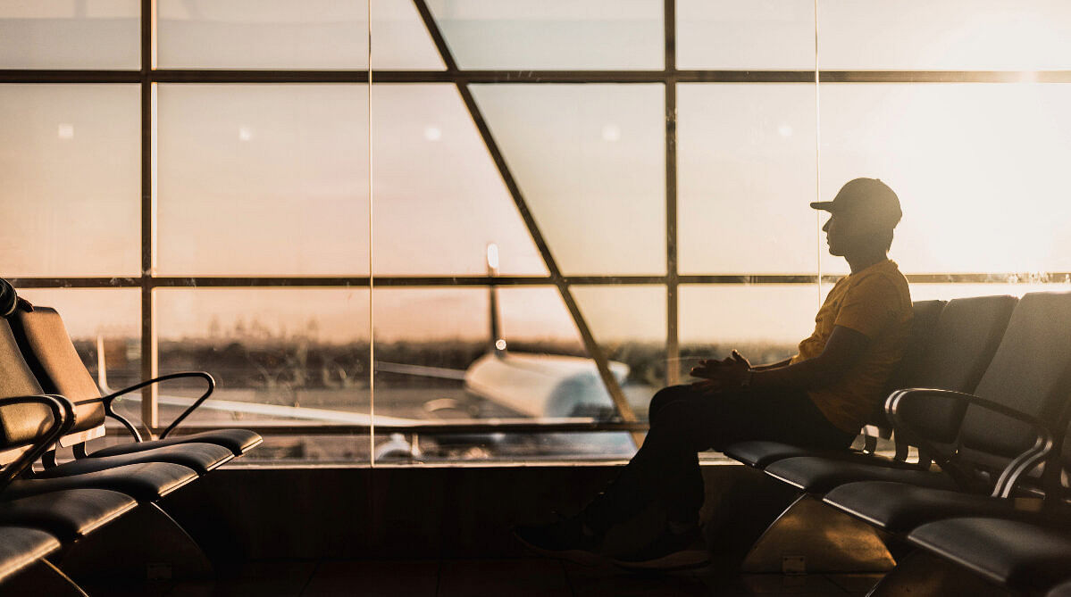 man sitting in an airport terminal
