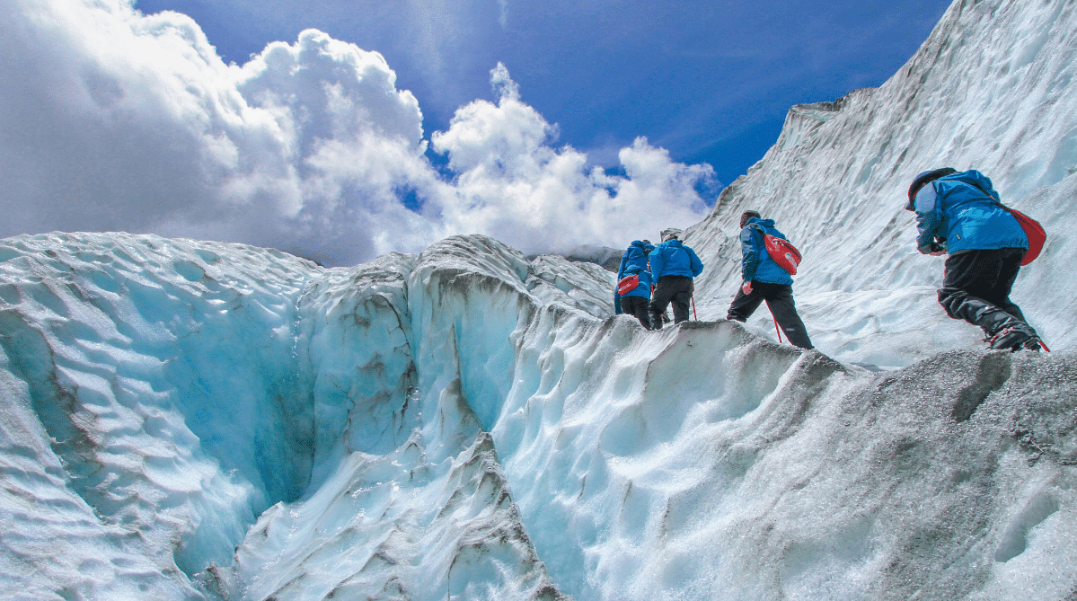 People trekking through Franz Josef Glacier