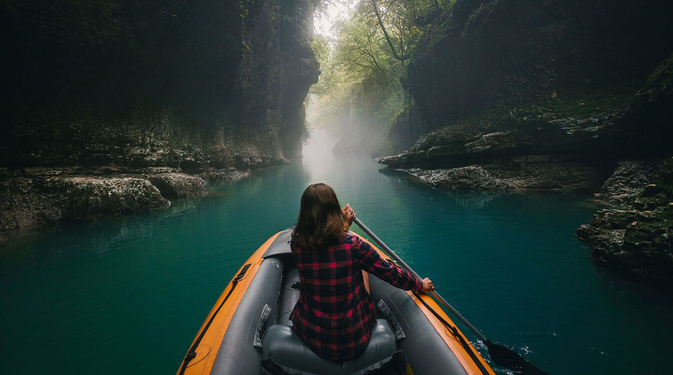 Girl rowing a boat through Martvili Canyon, Georgia