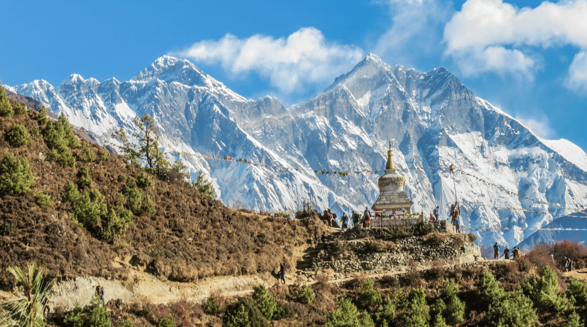 View of the Annapurna Sanctuary with snowy mountains and a clear blue sky during the day