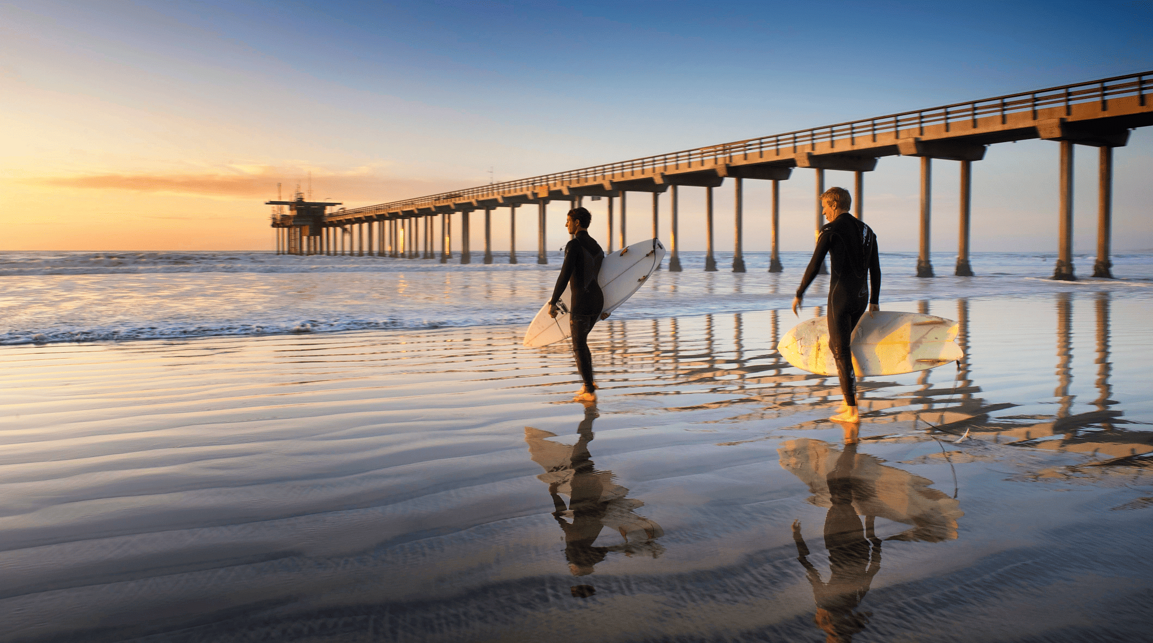 Surfers at sunset in San Diego, California