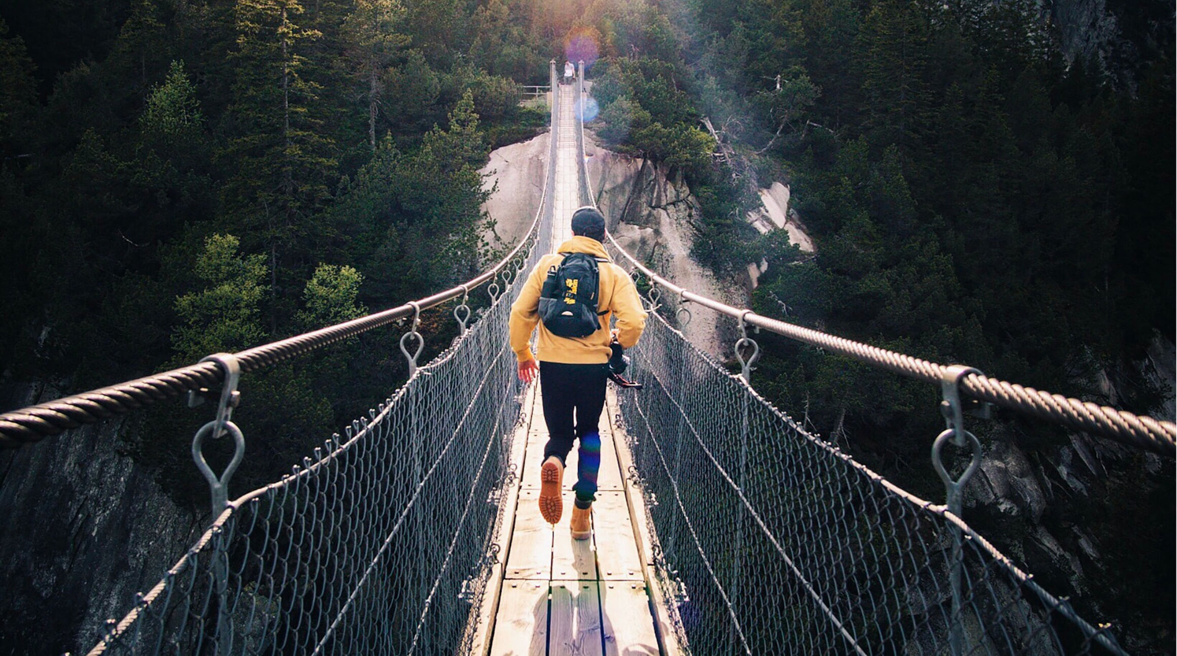 traveler running on a suspension bridge