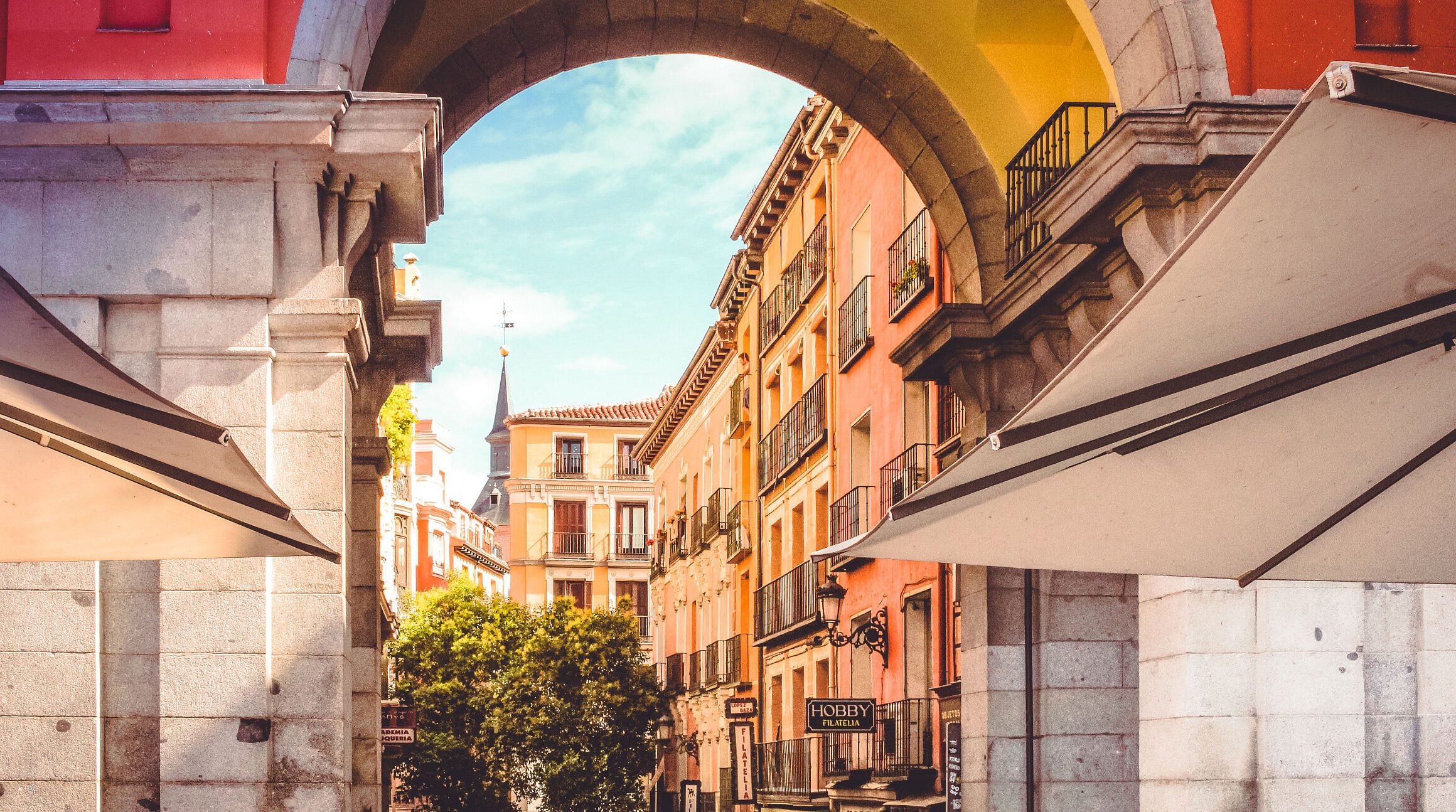 Street view of archway and buildings in Madrid, Spain