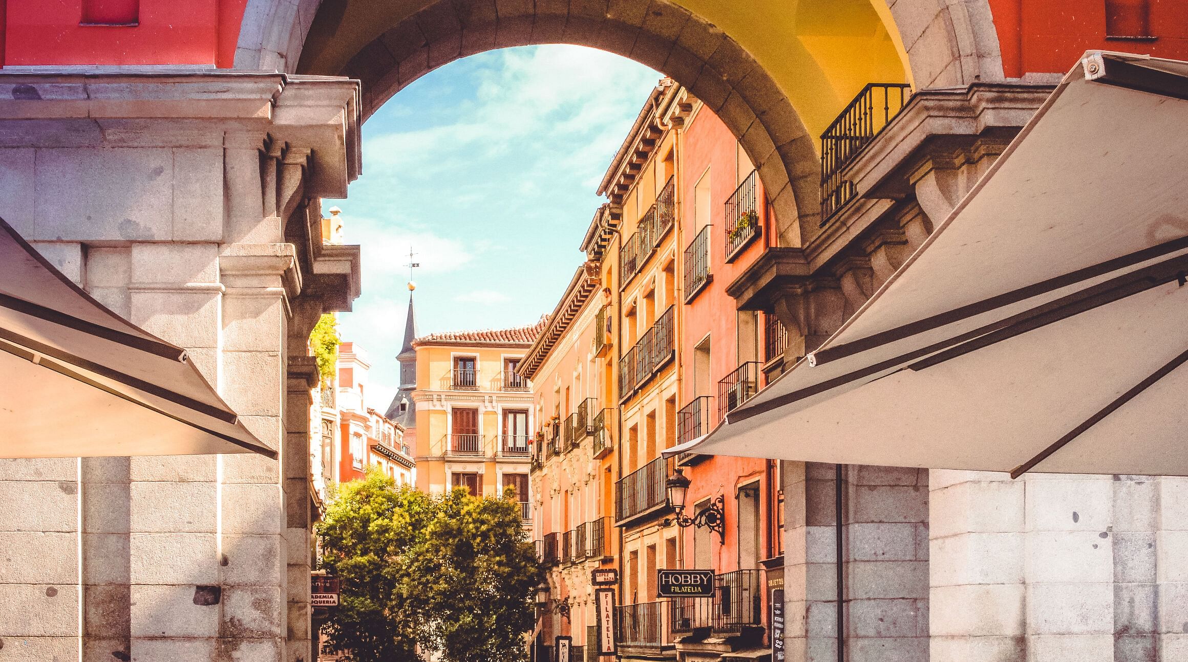 Street view of archway and buildings in Madrid, Spain