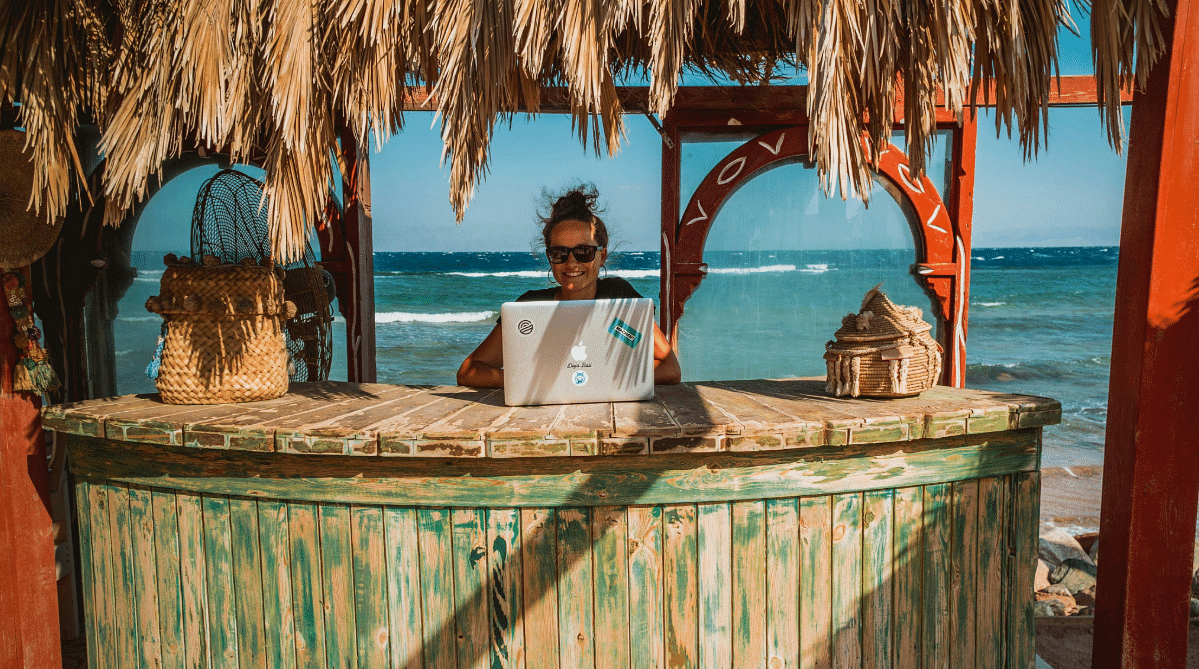 digital nomad working on the beach