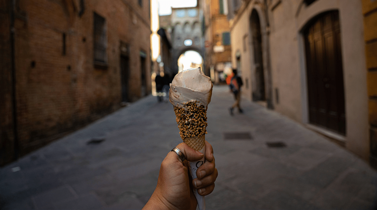 Hand holding gelato in Siena, Italy