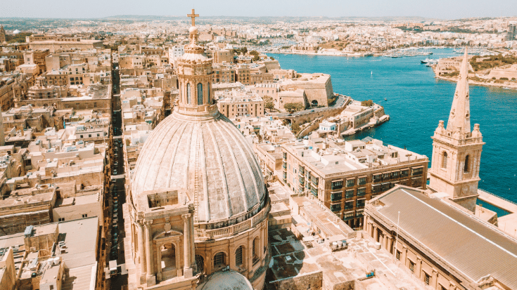 A colour photograph of Our Lady of Mount Carmel Basilica, a domed cathedral that overlooks Valletta, Malta.