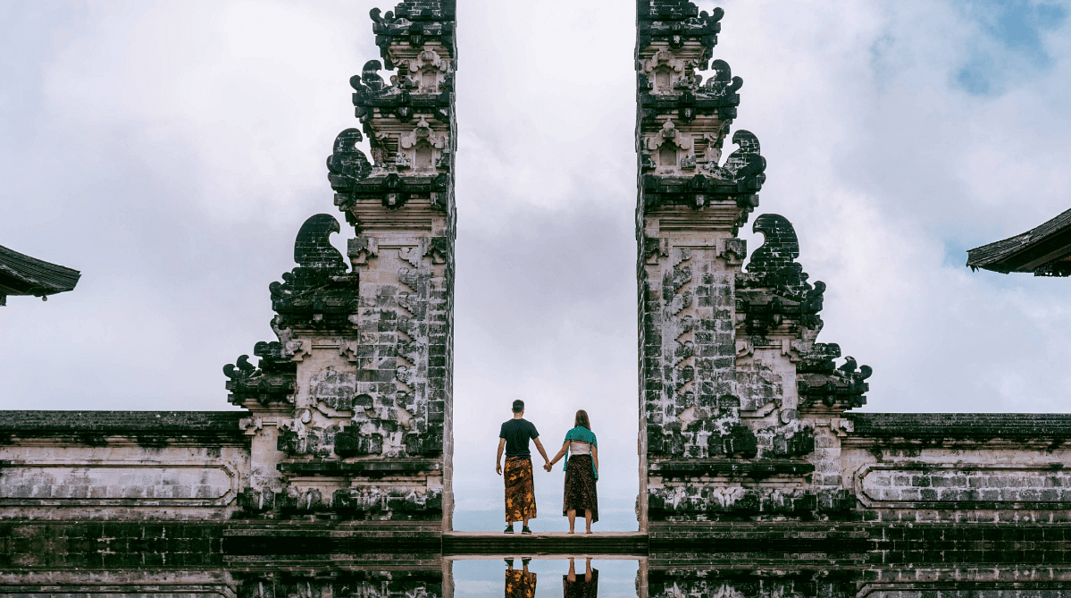 Couple standing at the Gates of Heaven, Lempuyang Temple, Bali